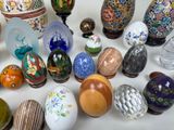 many different types of decorative eggs on the table