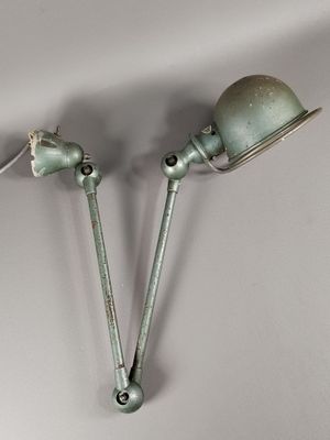 pair of vintage industrial style wall lights in the shape of two lamps
