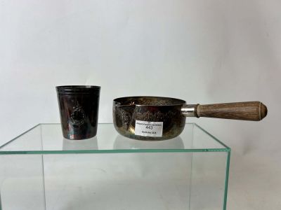 two bowls and a spoon sitting on a glass table