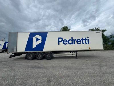 a white truck with a blue and white logo parked in a parking lot