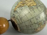 a small globe with a wooden ball attached to it