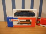 a toy train that is sitting on a table next to a box