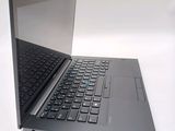 a laptop that is open on a white surface