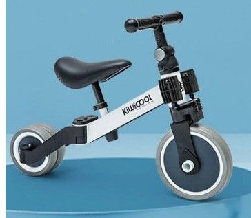 an image of a tricycle with wheels on a blue surface