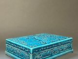 two blue boxes sitting on top of a table next to each other