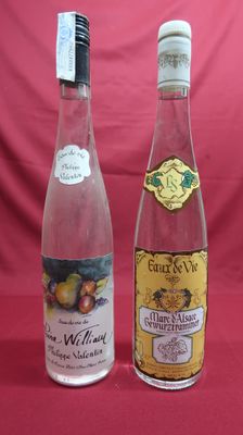 two bottles of wine sitting next to each other on a table