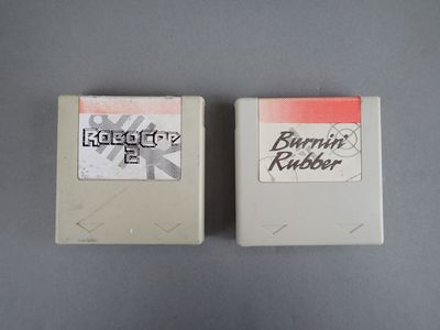 two nintendo games sitting next to each other on a table