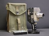 a camera that is sitting next to a bag