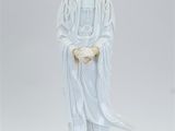 statue of a woman with a white robe and a white hat