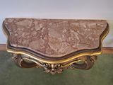 an image of a marble top table on a green carpet