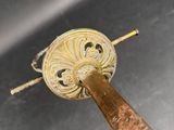 a metal object with a wooden stick sticking out of it