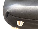 a close up of a black bag on a table