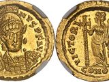 a gold coin with an image of a man and a woman on it
