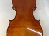 an old violin sitting on top of a table next to a wall