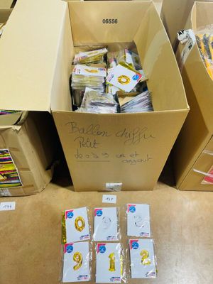 several boxes of mail are sitting on the floor next to each other