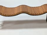 a wooden bench with black hairpin legs on a white background