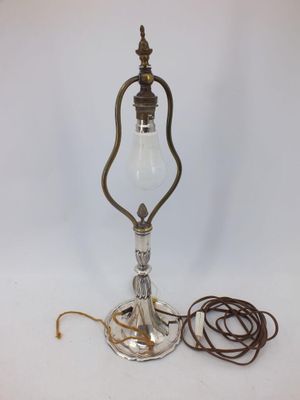 an old fashioned lamp with a cord attached to it