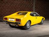 a yellow car that is parked in a garage