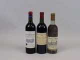 three bottles of wine are sitting next to each other on a white surface