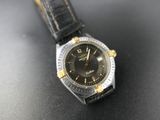 a close up of a watch on a table