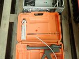 two orange cases with tools in them sitting on a pallet