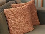 a couch with a pillow on it in a living room