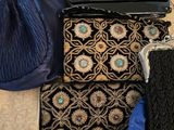 many bags and purses laid out on the floor