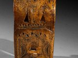an old wooden box sitting on top of a white surface