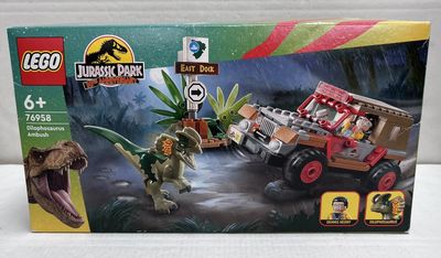 the box is open to show the contents of the lego jurassic jeep