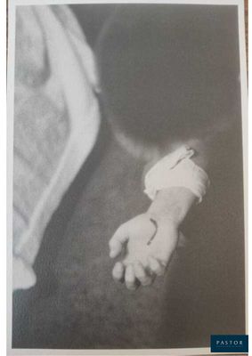 black and white photograph of a person holding a baby ' s hand