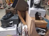 a pile of boxes and boxes of shoes in a warehouse