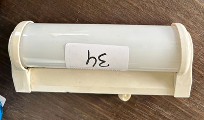 a toothbrush and a toothpaste holder on a table