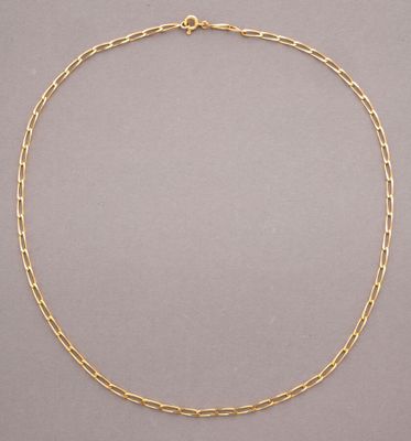 a gold chain necklace with a link on a grey background