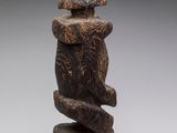 an image of a sculpture of a bird sitting on top of a tree stump