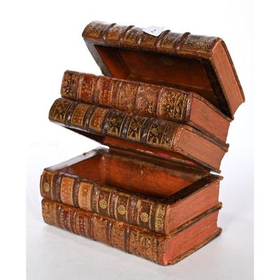 three books stacked on top of each other on a white surface