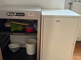 a small refrigerator in the corner of a room