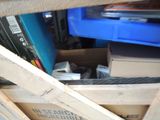 a cat that is sitting in a box under a shelf