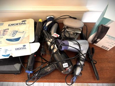 many hair dryers and hairdryers on a table