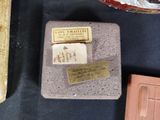 a plaque on the table next to a knife and other items