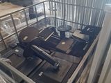 a metal basket filled with assorted electronics in a warehouse