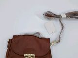 brown leather handbag with a tassel on a white background