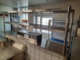 a kitchen with stainless steel counter tops and a sink