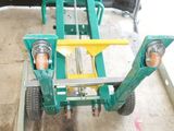 un chariot vert avec une poignée jaune dans un garage