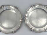 a pair of silverplated dishes with floral decoration