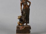 bronze statue of a woman with a child on a marble base