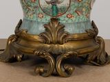 an image of a vase on a table with a clock on it