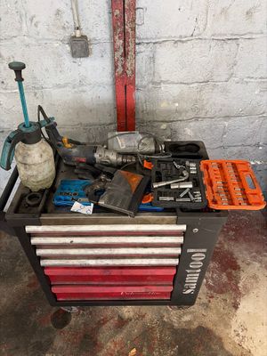 a tool box with tools on it in a garage