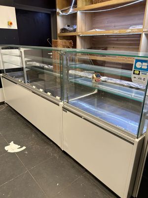 a glass display case in the middle of a store