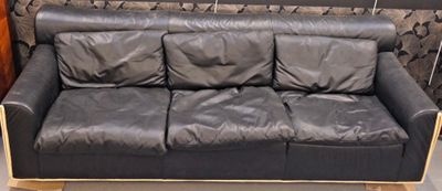 a black leather couch that is on display in a store