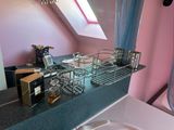 a sink and a mirror in a bathroom with a pink wall